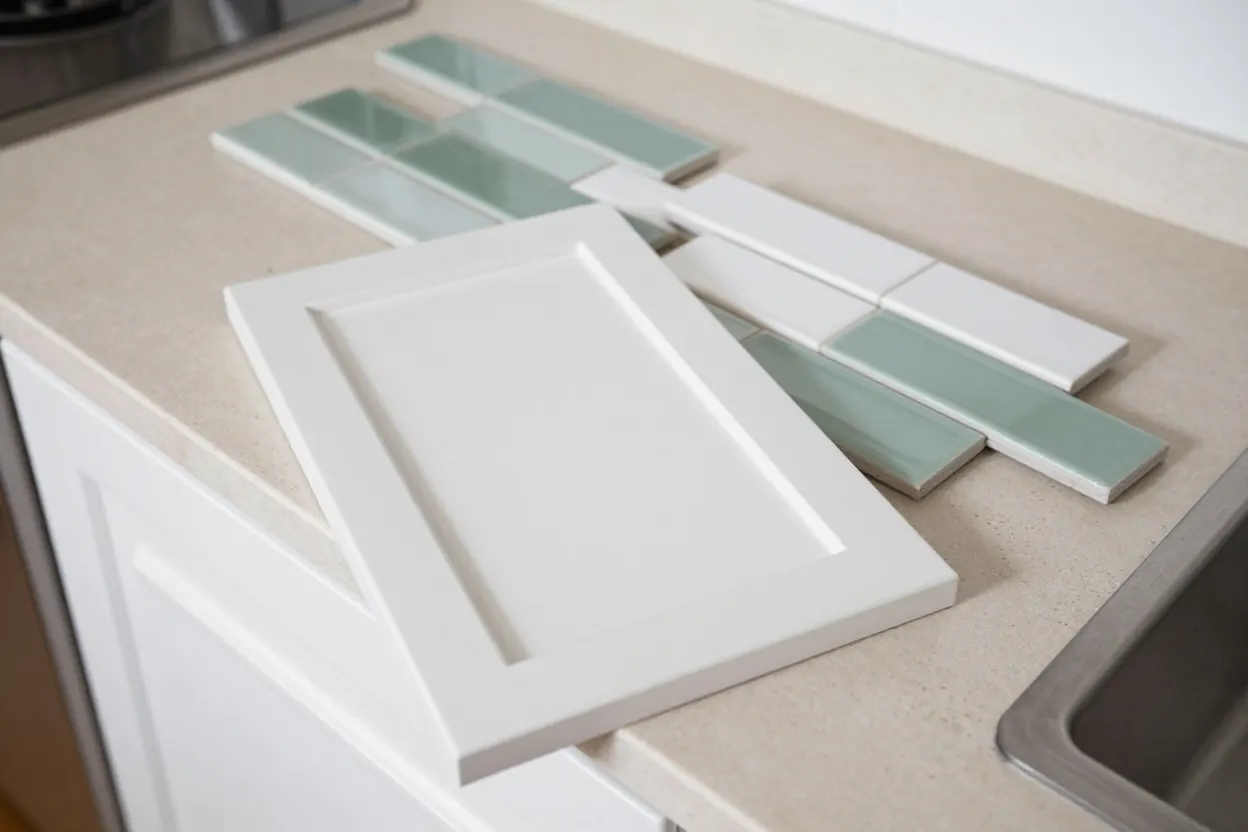 Cabinet door, countertop and backsplash samples laid out together