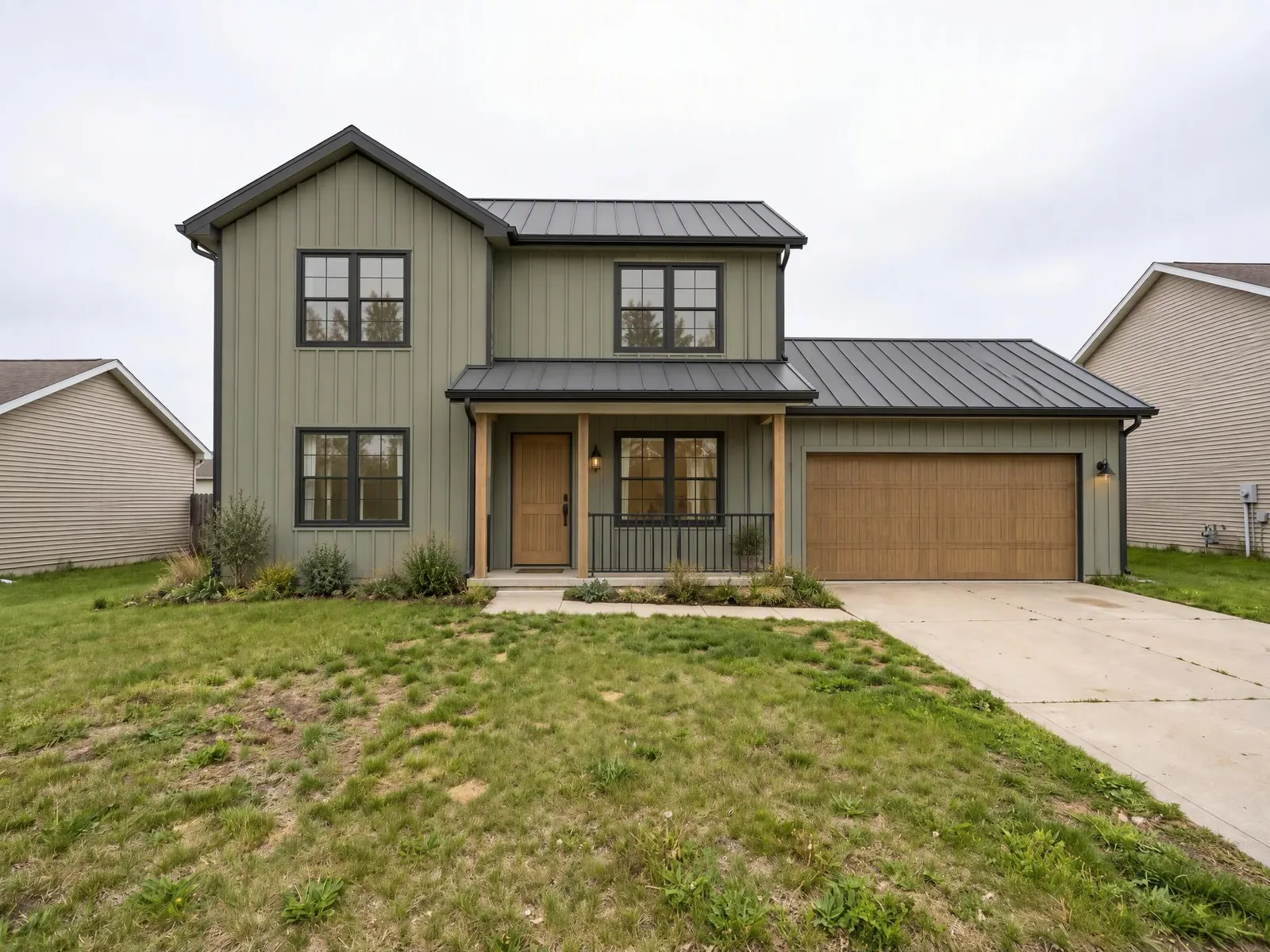 House exterior before and after: beige vinyl to sage board and batten
